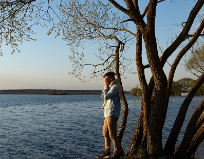 Traveler standing beside peaceful lake